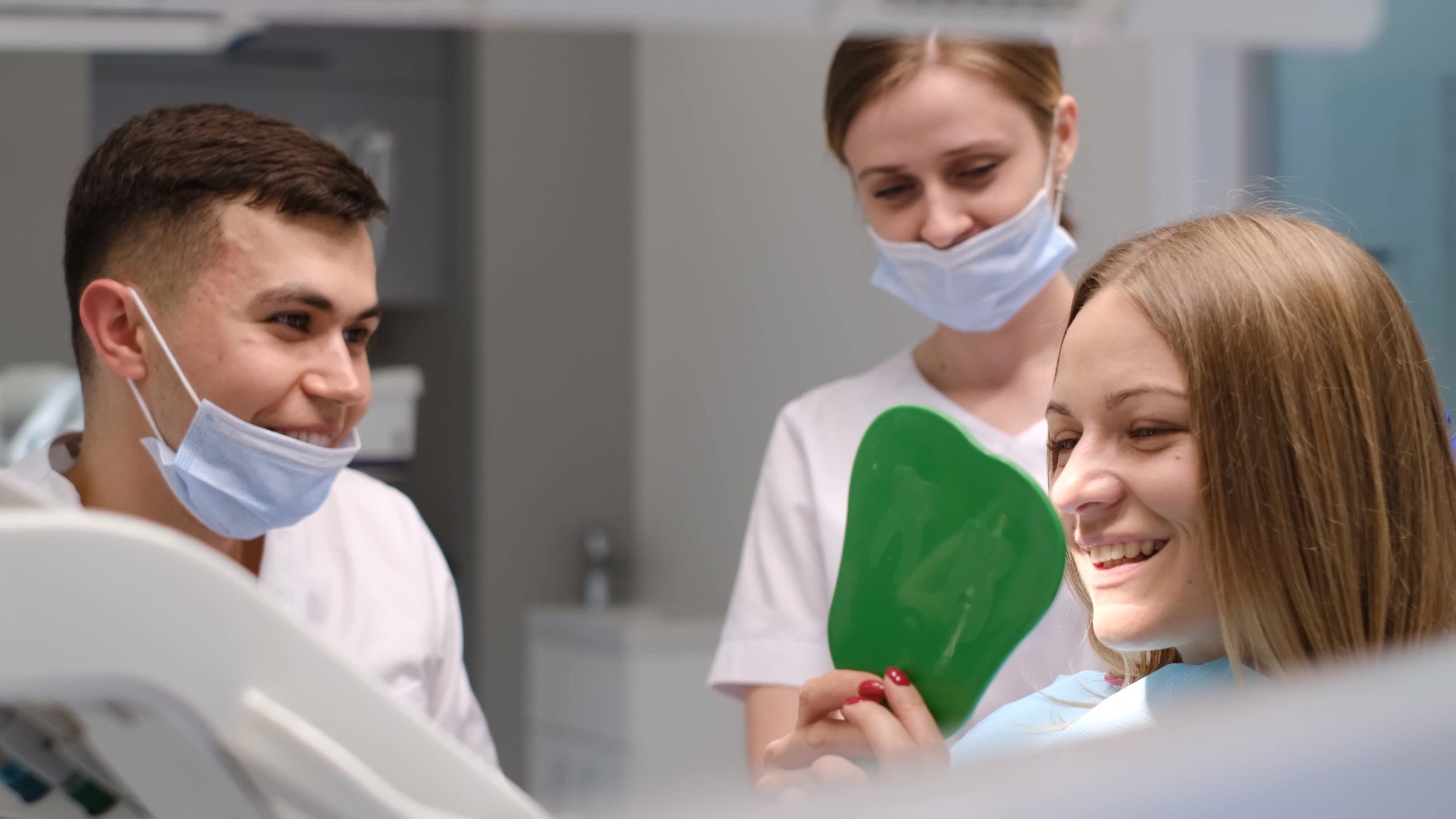 A smiling patient receiving a dental implant consultation at Implant & Cosmetic Dentistry of Northern Indiana in Crown Point, IN; phone 360-800-2013.